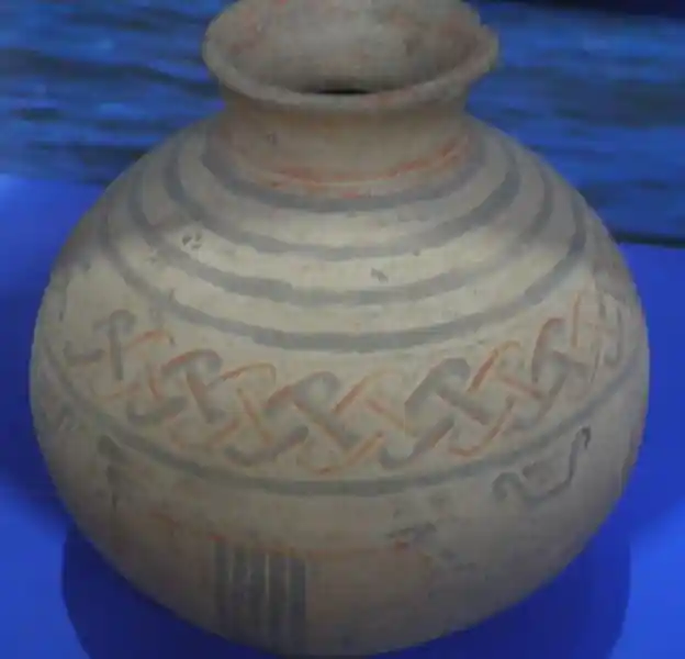 Vase, interlocking swastikas, solar disc on the mouth